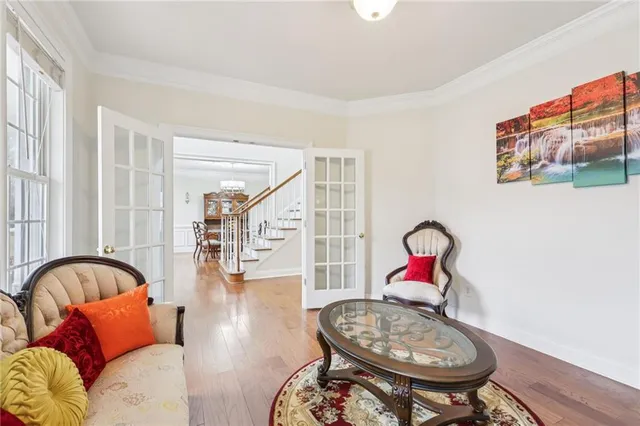 a living room with furniture a rug and white walls