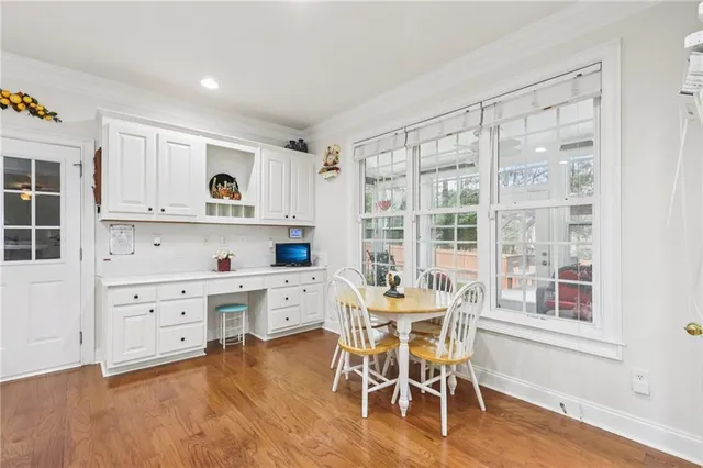 a view of a kitchen with furniture and wooden floor