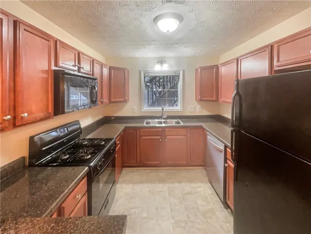 a kitchen with a refrigerator stove and sink