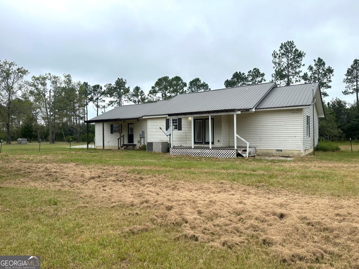 1296 Boone Road Adel, GA 31620 - Photo 17 of 20 a front view of a house with a garden