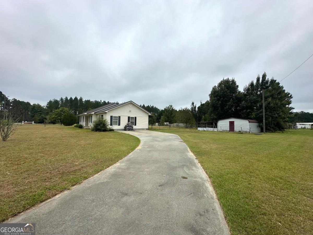 1296 Boone Road Adel, GA 31620 - Photo 20 of 20 a front view of a house with a yard