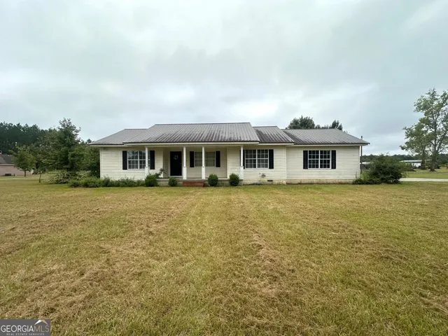 a front view of a house with a yard table and chairs