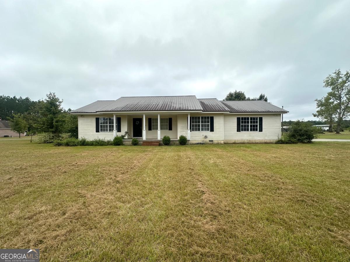 1296 Boone Road Adel, GA 31620 - Photo 2 of 20 a front view of a house with a yard table and chairs