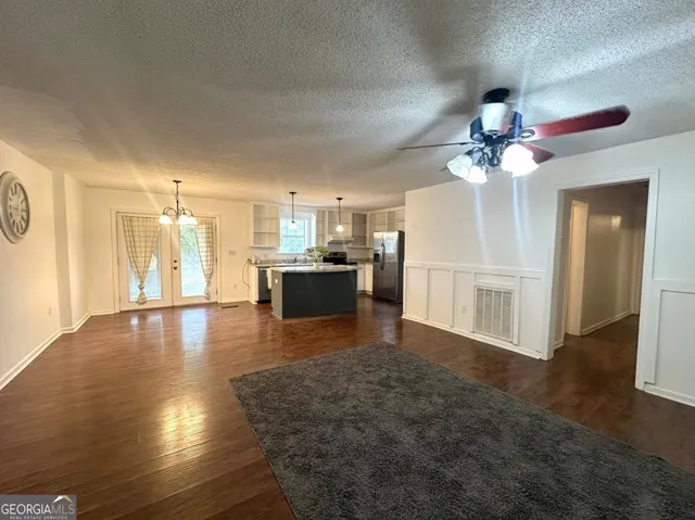 a view of a livingroom with a kitchen