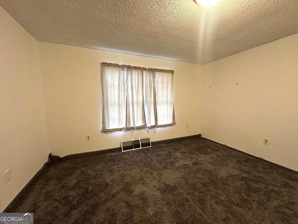 1296 Boone Road Adel, GA 31620 - Photo 9 of 20 an empty room with a window