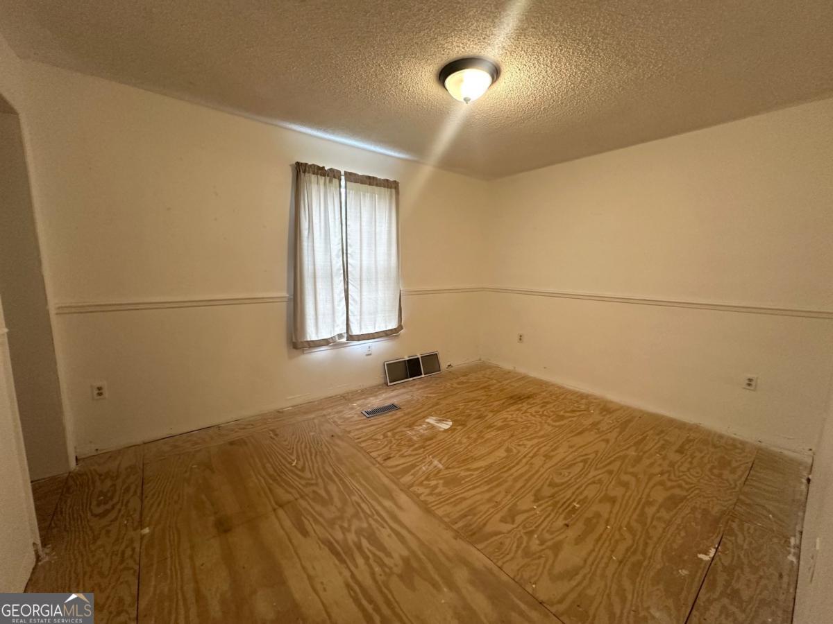 1296 Boone Road Adel, GA 31620 - Photo 10 of 20 a bedroom with a bed and a window