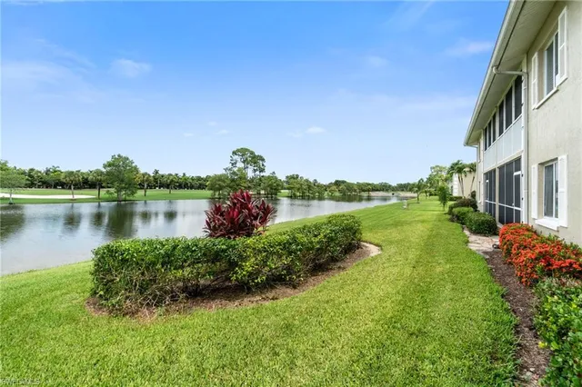 a view of a lake with houses in the background