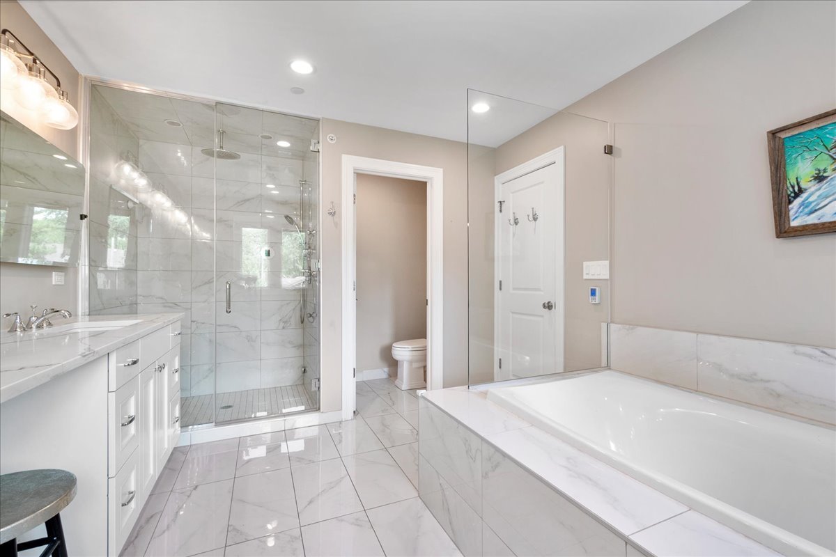 2921 Simpson Street Evanston, IL 60201 - Photo 19 of 41 a spacious bathroom with a granite countertop sink a shower and a mirror