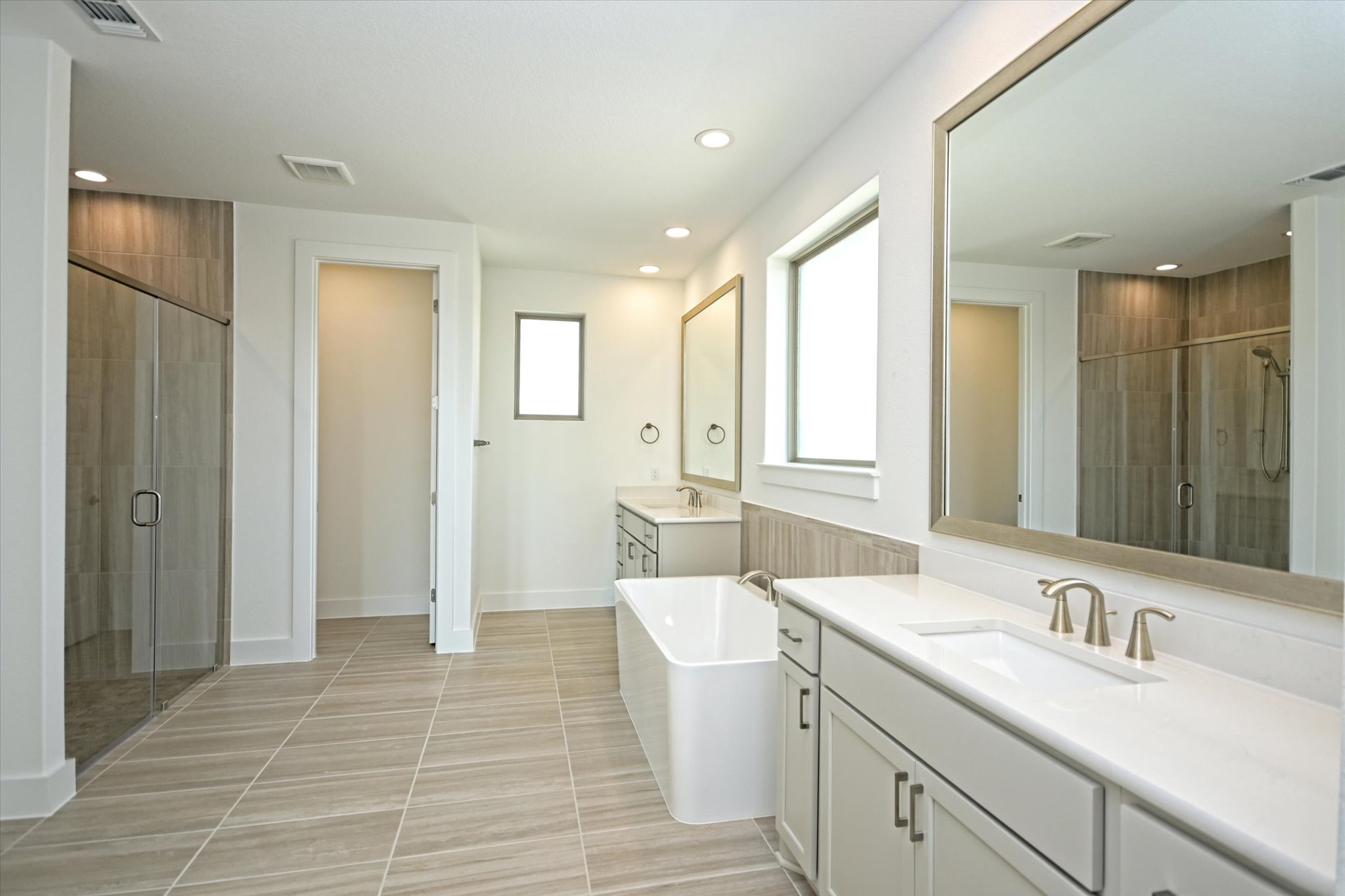 217 Scofield Avenue Georgetown, TX 78626 - Photo 16 of 31 a spacious bathroom with a double vanity sink a mirror and a shower