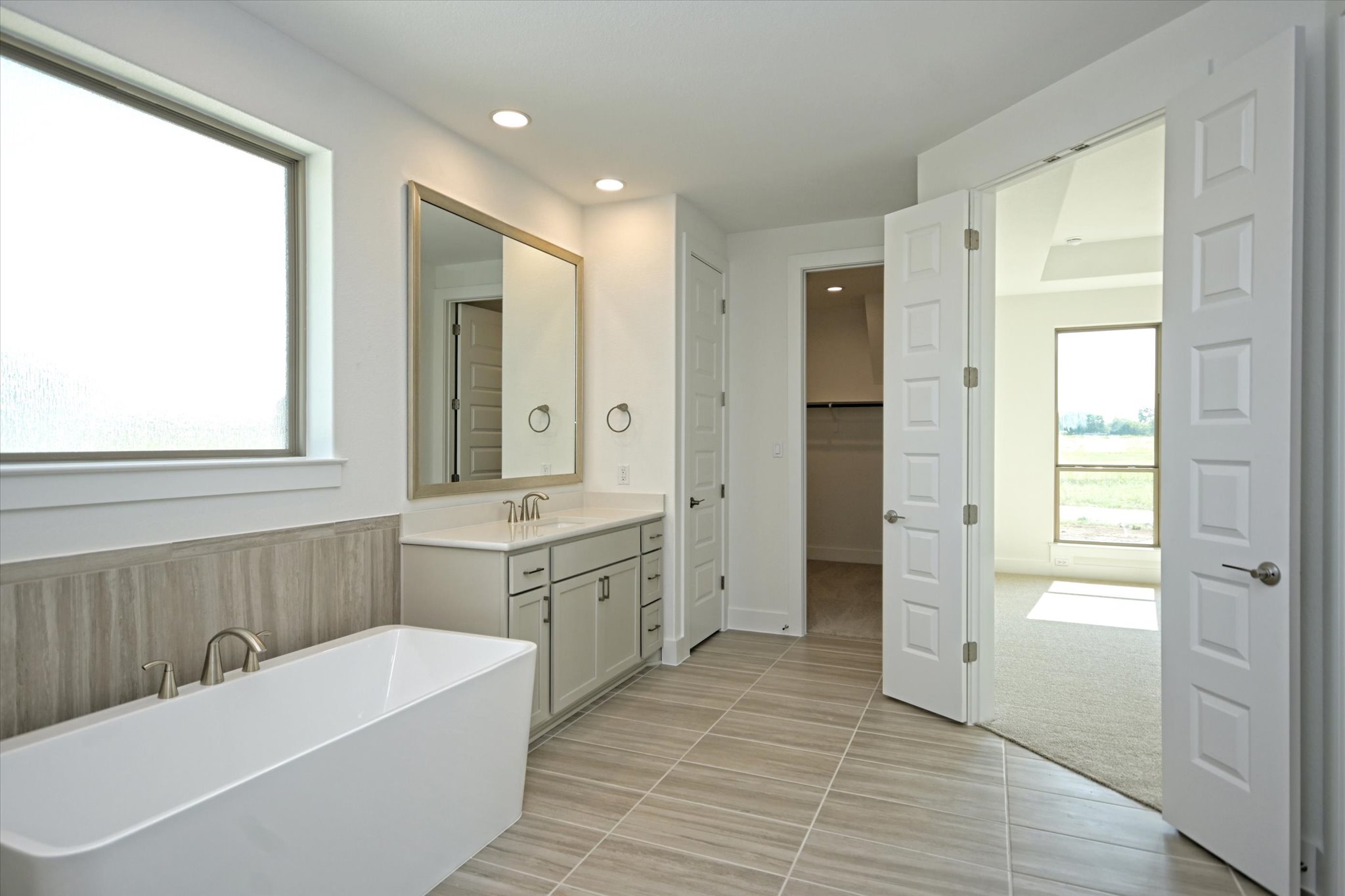 217 Scofield Avenue Georgetown, TX 78626 - Photo 17 of 31 a bathroom with a tub sink and mirror