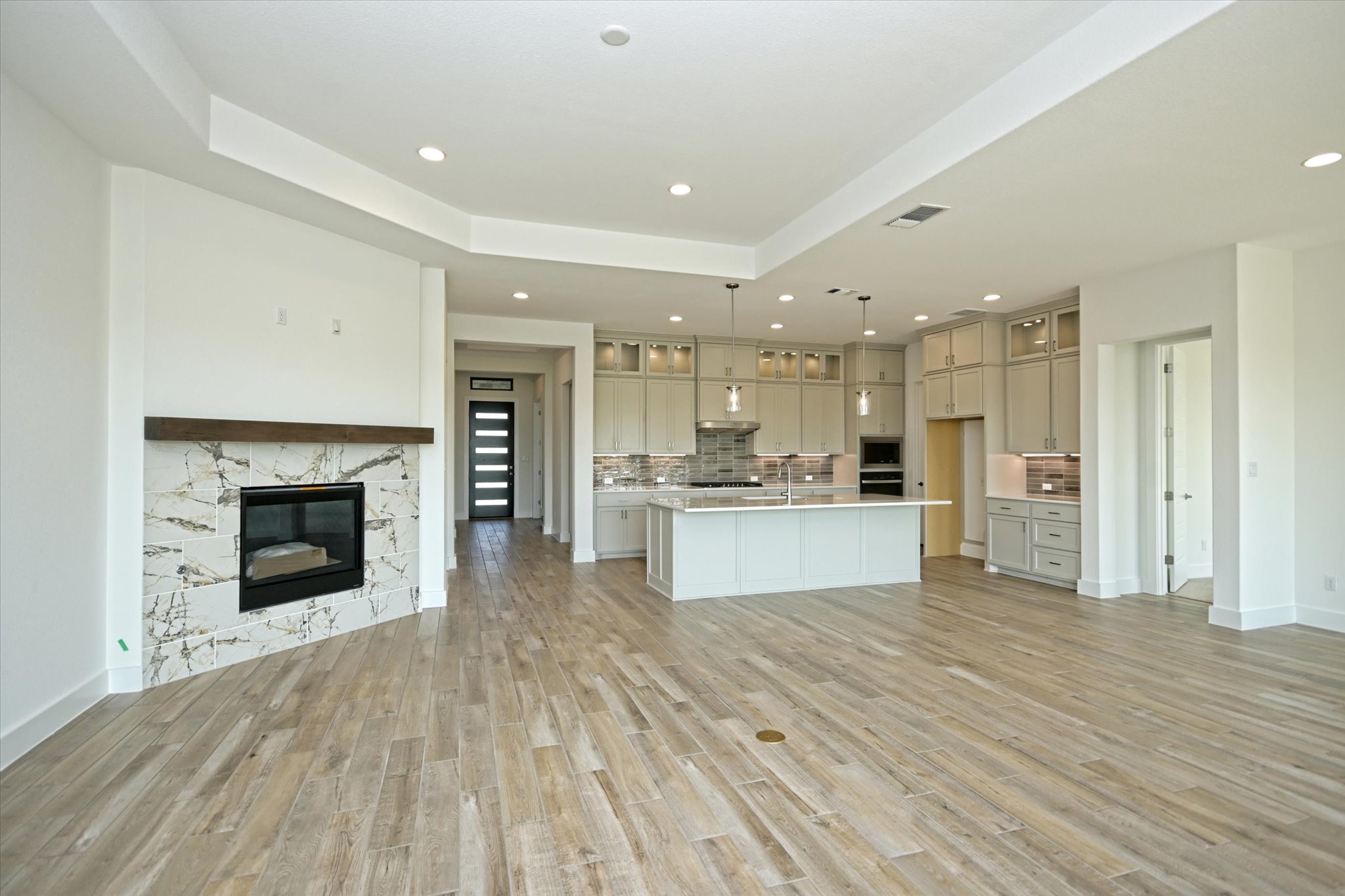 217 Scofield Avenue Georgetown, TX 78626 - Photo 5 of 31 a large white kitchen with a refrigerator a stove and kitchen island