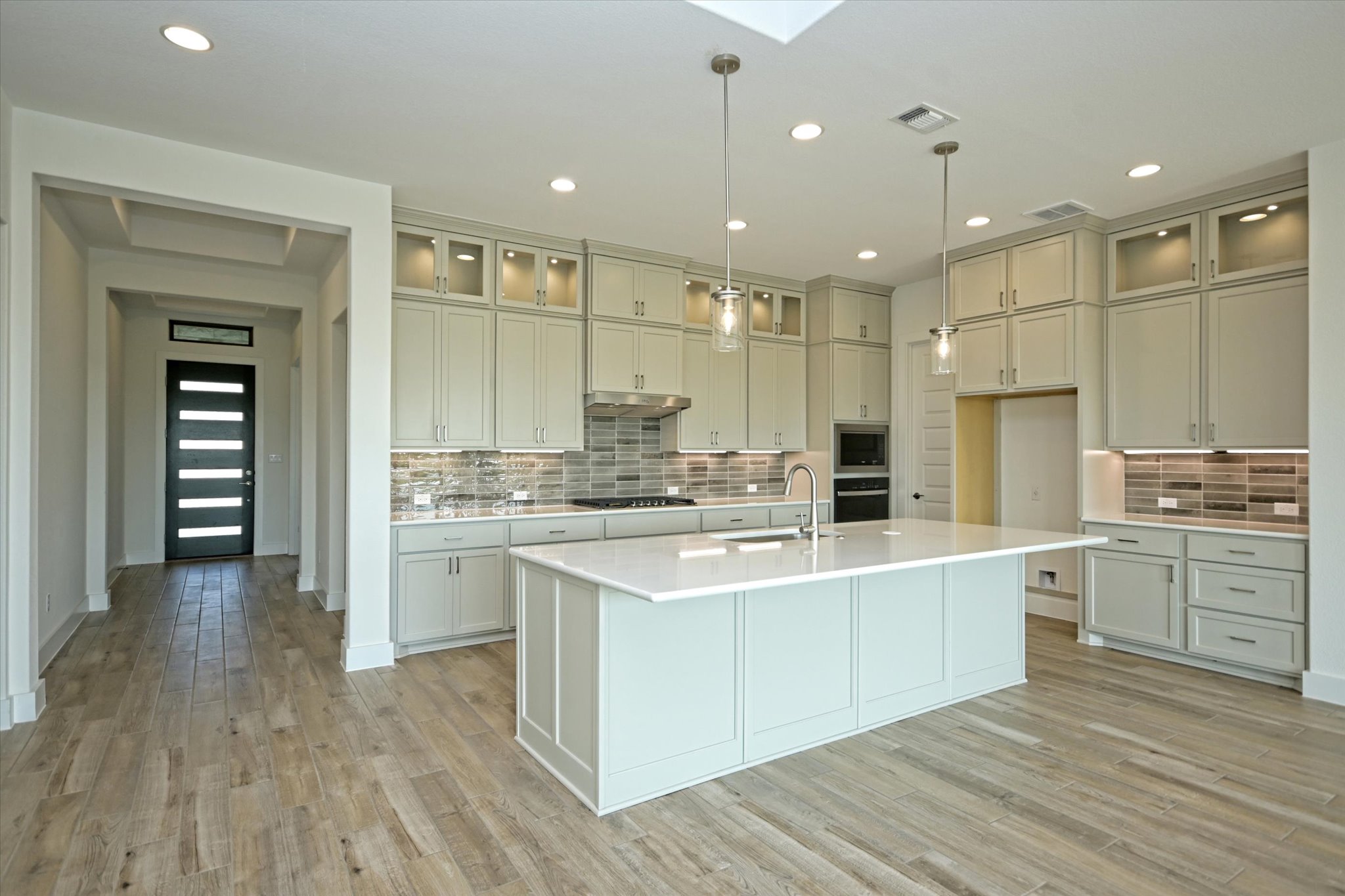 217 Scofield Avenue Georgetown, TX 78626 - Photo 7 of 31 a large kitchen with kitchen island a sink stainless steel appliances and cabinets