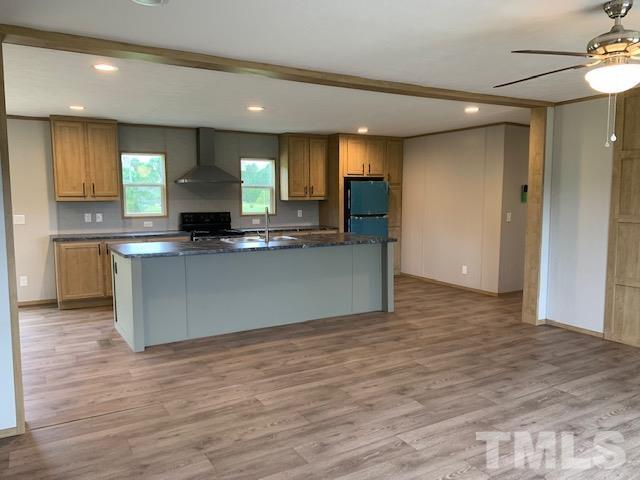 2261 Shoeheel Road Selma, NC 27576 - Photo 4 of 16 a view of kitchen with granite countertop cabinets and a counter top space