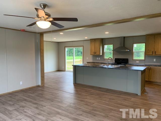 2261 Shoeheel Road Selma, NC 27576 - Photo 5 of 16 a view of kitchen with granite countertop cabinets and window