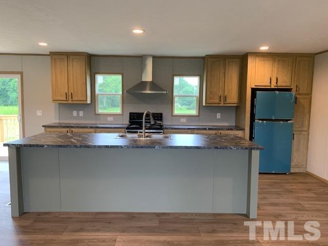 2261 Shoeheel Road Selma, NC 27576 - Photo 6 of 16 a kitchen with stainless steel appliances granite countertop a sink a stove and a refrigerator