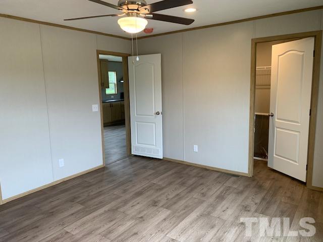 2261 Shoeheel Road Selma, NC 27576 - Photo 8 of 16 wooden floor in an empty room with a window