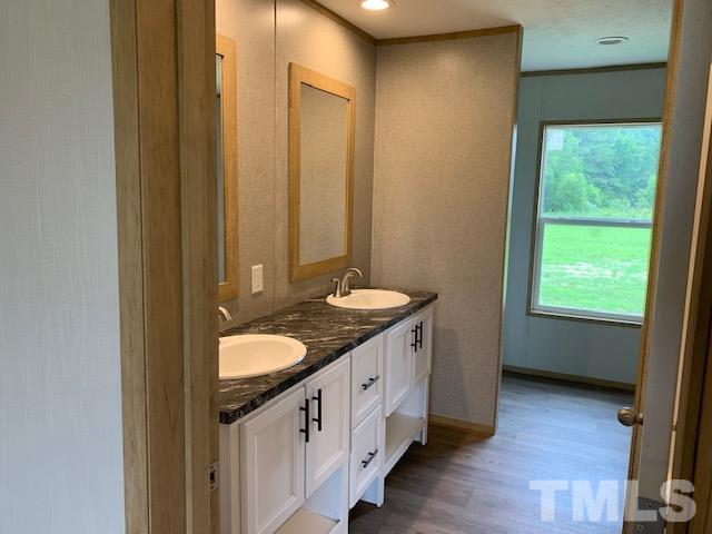 2261 Shoeheel Road Selma, NC 27576 - Photo 9 of 16 a bathroom with a granite countertop sink and a mirror