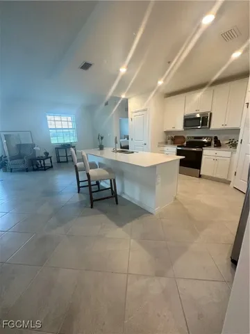 a large white kitchen with a large window