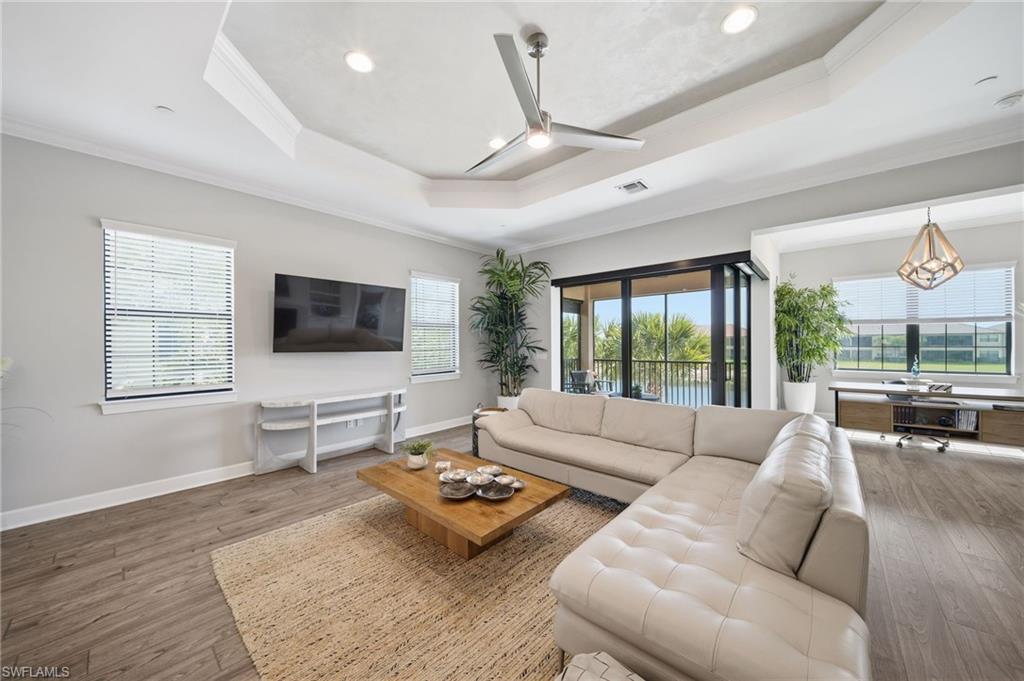 9658 Montelanico Loop, Unit 201 Naples, FL 34119 - Photo 9 of 46 a living room with furniture and a flat screen tv