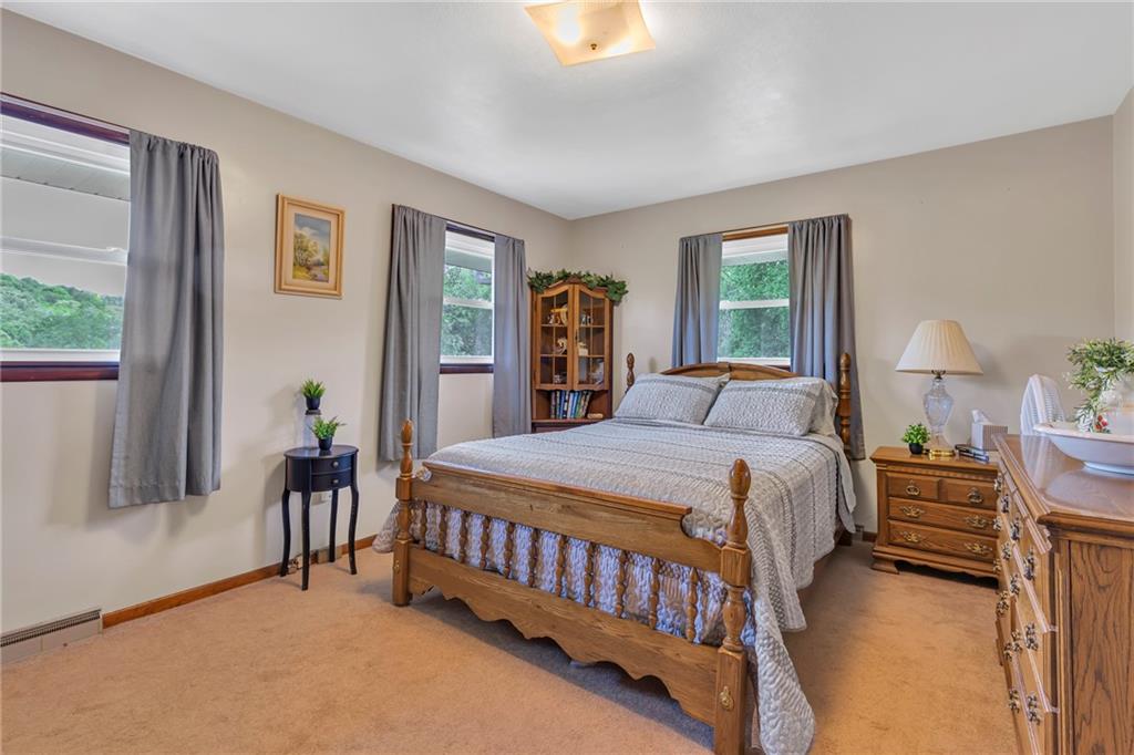 383 Ridgemont Drive Midland, PA 15059 - Photo 33 of 44 a bedroom with a bed and a chandelier