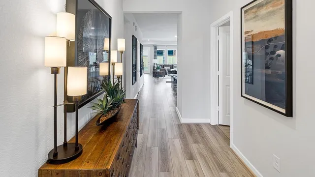 a view of a hallway with wooden floor and staircase