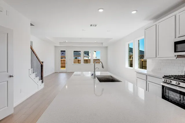 a hallway with furniture and a stove top oven