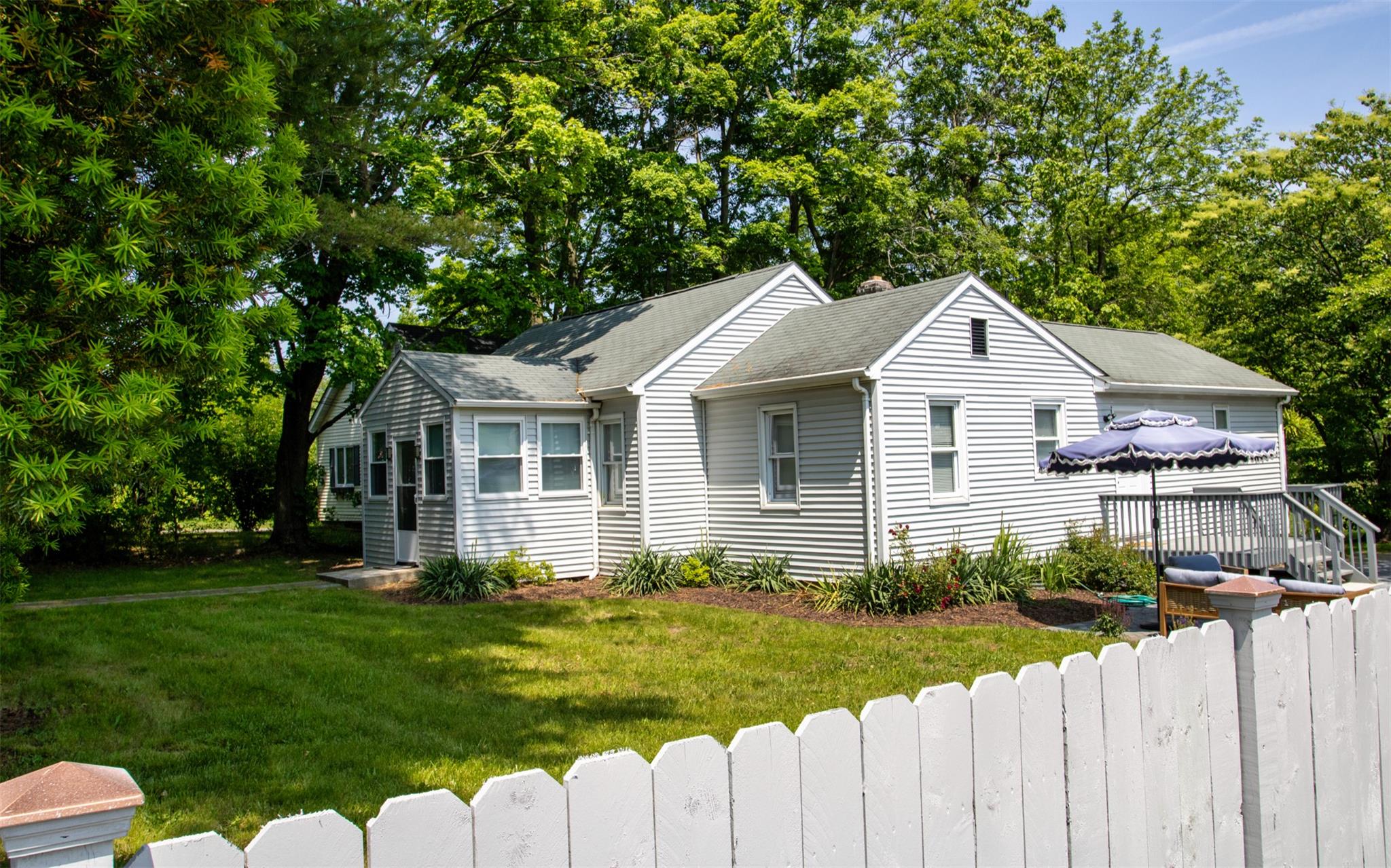 a front view of house with yard and green space