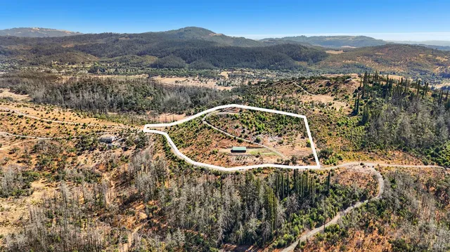 an aerial view of mountain with yard
