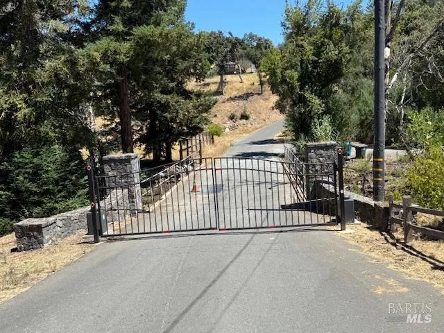 a view of a fence and trees