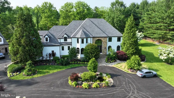 a house with lots of trees in the background