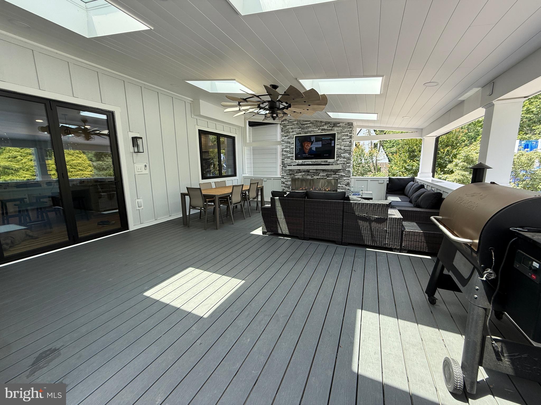 821 Burrows Run Road Chadds Ford, PA 19317 - Photo 133 of 146 a living room with furniture a flat screen tv and a floor to ceiling window