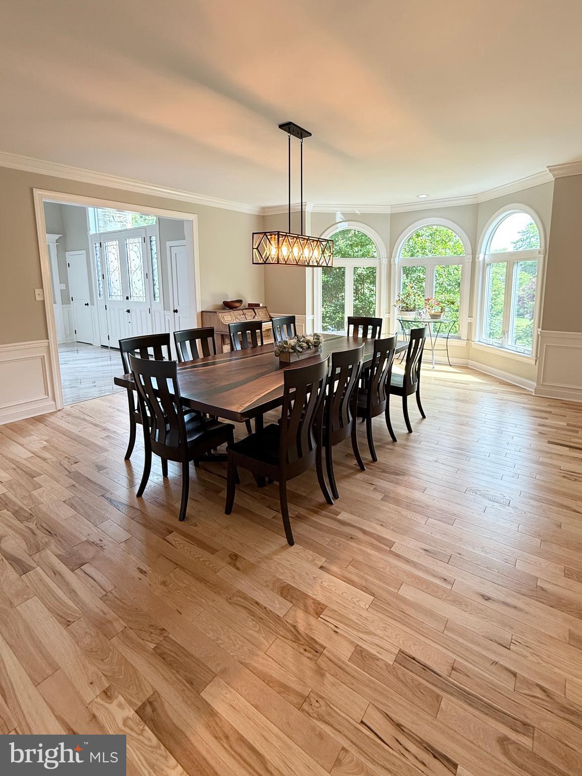 821 Burrows Run Road Chadds Ford, PA 19317 - Photo 22 of 146 a dining room with wooden floor a chandelier a wooden table and chairs