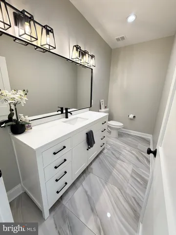 a spacious bedroom with a bed and a flat screen tv