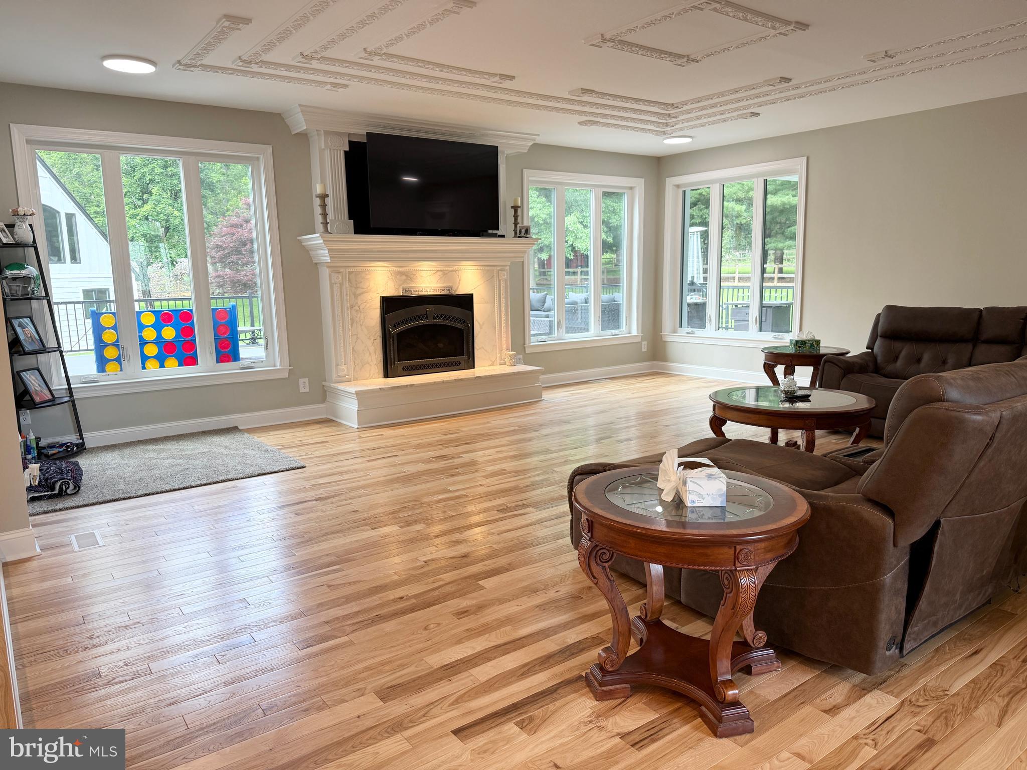 821 Burrows Run Road Chadds Ford, PA 19317 - Photo 25 of 146 a living room with furniture a flat screen tv and a fireplace