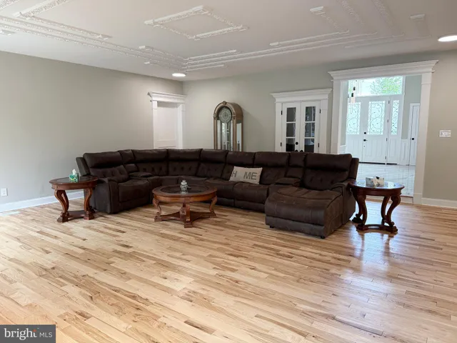 a spacious bathroom with a granite countertop sink a toilet a mirror and shower