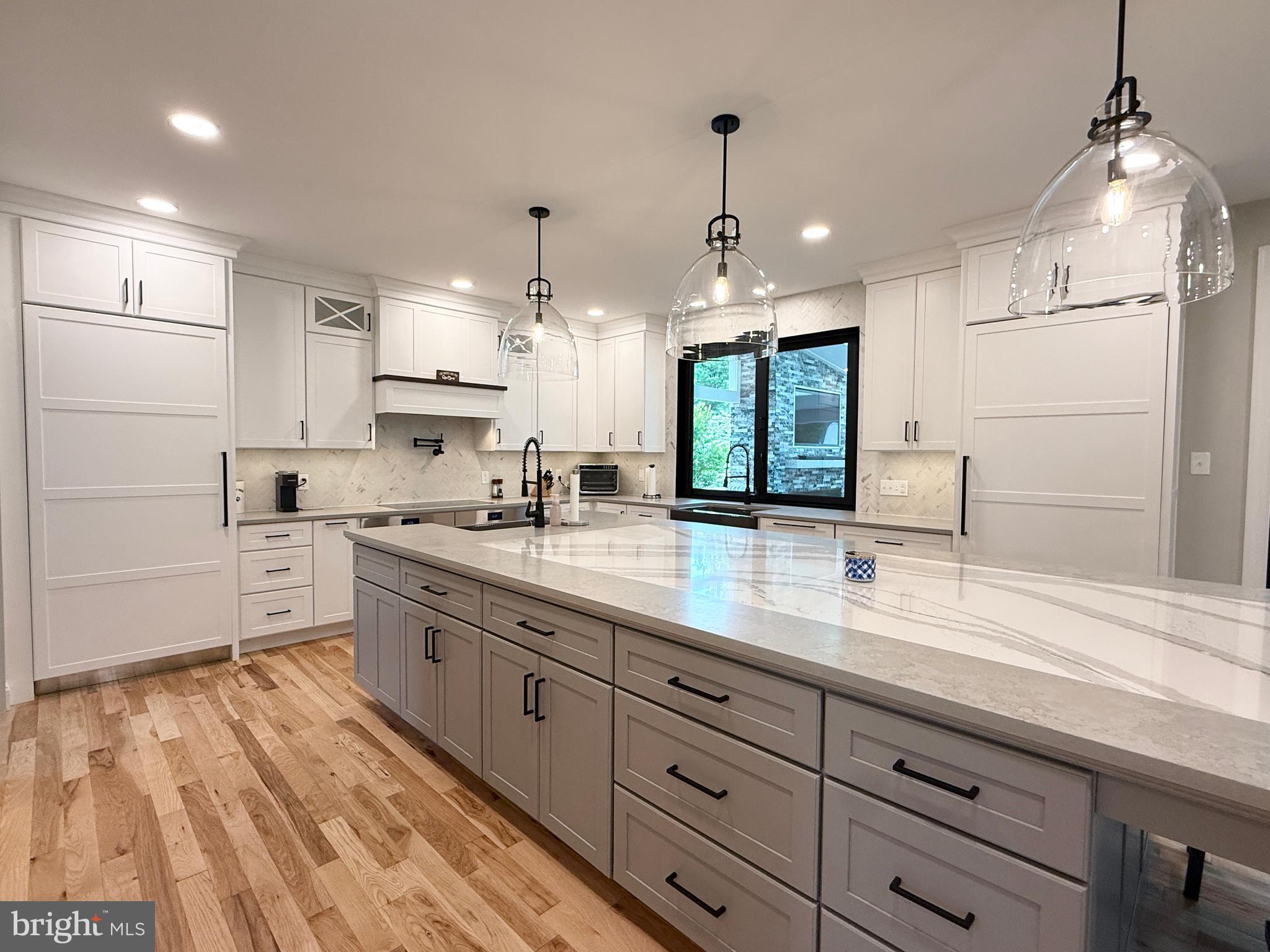 821 Burrows Run Road Chadds Ford, PA 19317 - Photo 36 of 146 a large kitchen with granite countertop a large white kitchen island a sink stainless steel appliances and cabinets