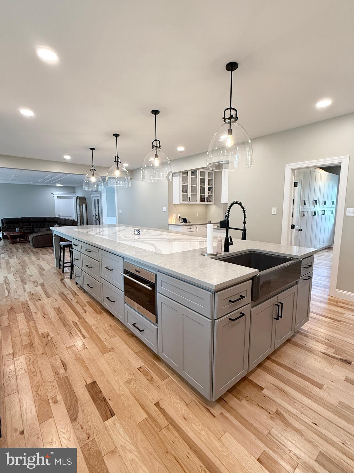 821 Burrows Run Road Chadds Ford, PA 19317 - Photo 40 of 146 a large kitchen with stainless steel appliances a stove a sink dishwasher and a dining table with wooden floor