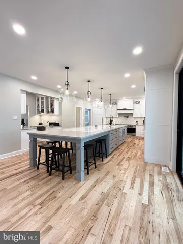 a bedroom with wooden floor and ceiling fan