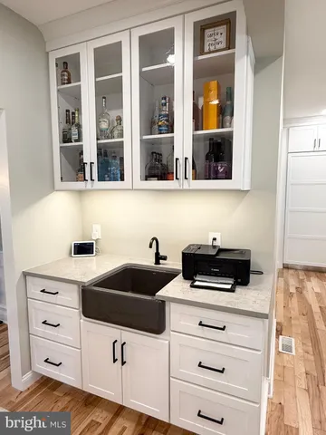a living room with furniture a flat screen tv and a large window