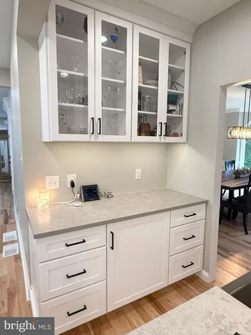 a living room with furniture a flat screen tv and a floor to ceiling window