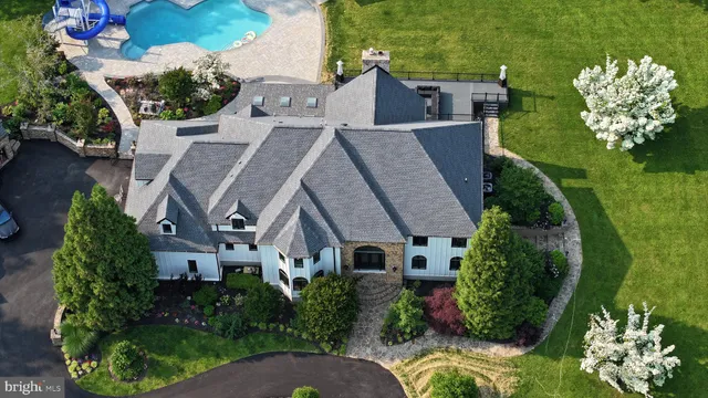 an aerial view of a house with garden space and street view