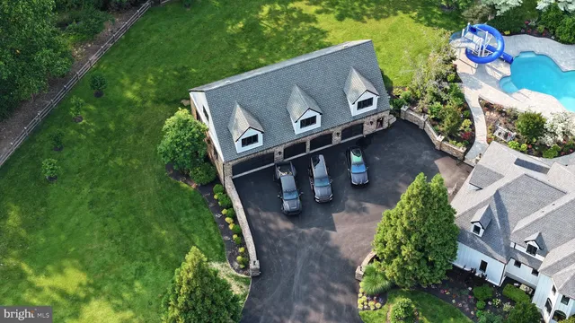 an aerial view of a house with yard swimming pool and outdoor seating