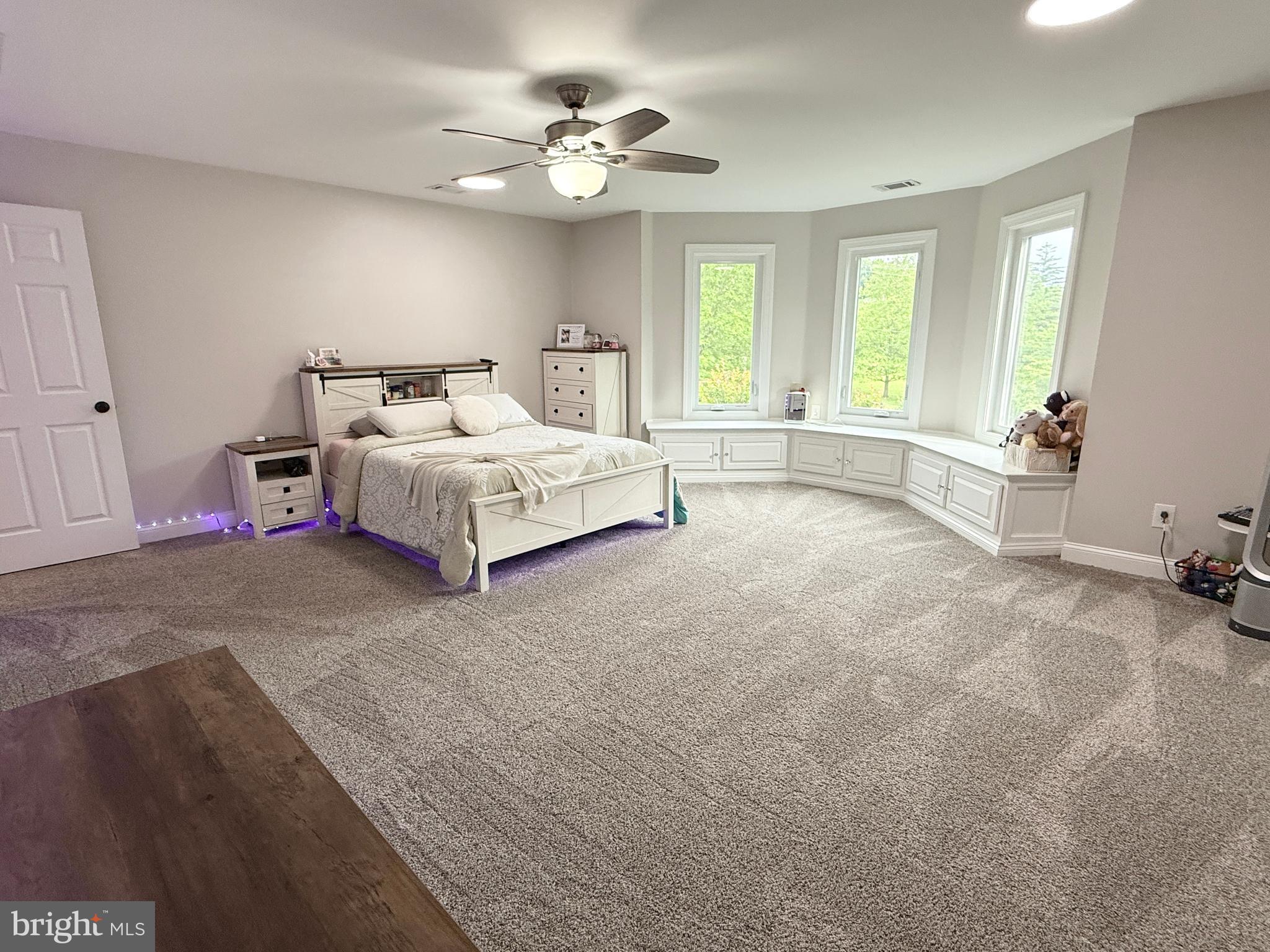821 Burrows Run Road Chadds Ford, PA 19317 - Photo 71 of 146 a spacious bedroom with a bed and a chandelier