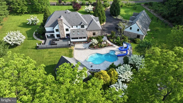 a dining room with wooden floor a chandelier a wooden table and chairs