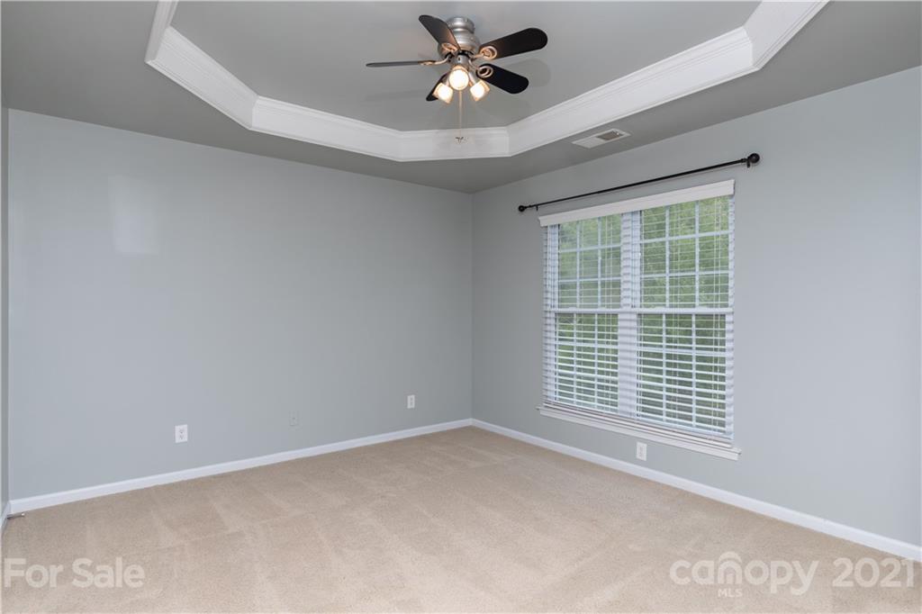 623 6th Baxter Crossing Fort Mill, SC 29708 - Photo 12 of 27 a view of an empty room with a window and a ceiling fan