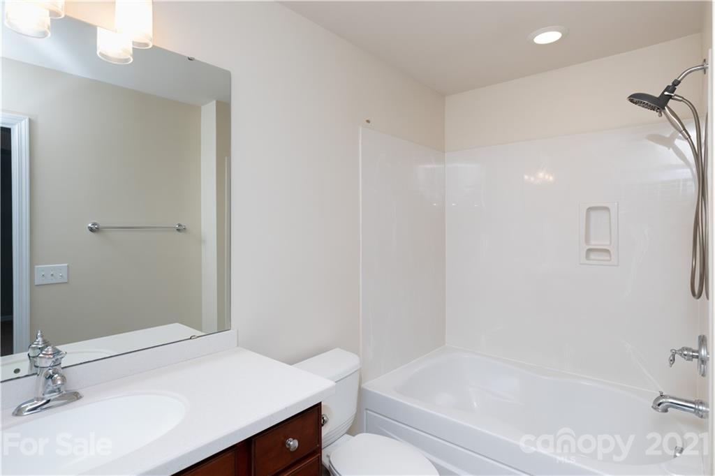 623 6th Baxter Crossing Fort Mill, SC 29708 - Photo 14 of 27 a bathroom with a bathtub shower sink vanity and toilet