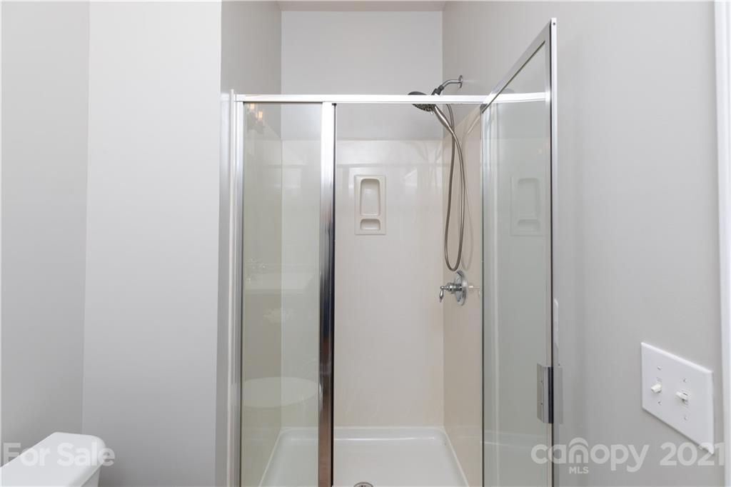 623 6th Baxter Crossing Fort Mill, SC 29708 - Photo 23 of 27 a bathroom with a glass shower door and mirror