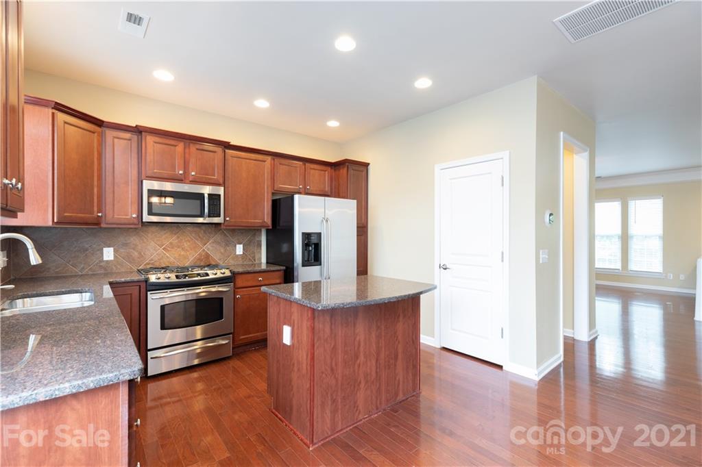 623 6th Baxter Crossing Fort Mill, SC 29708 - Photo 4 of 27 a kitchen with stainless steel appliances granite countertop a stove a sink and a microwave