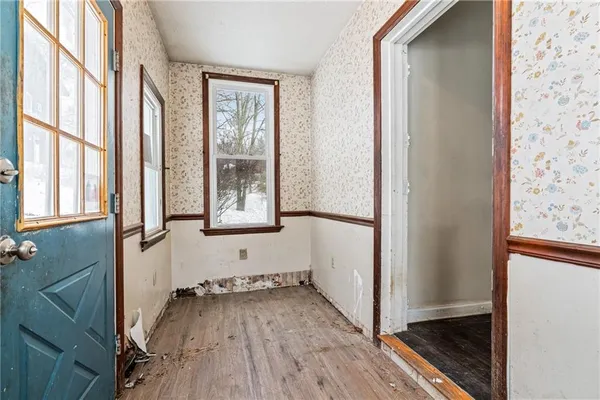 a view of a room with wooden floor and windows