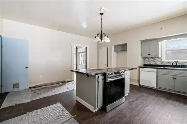 a kitchen with stainless steel appliances granite countertop a stove and a sink